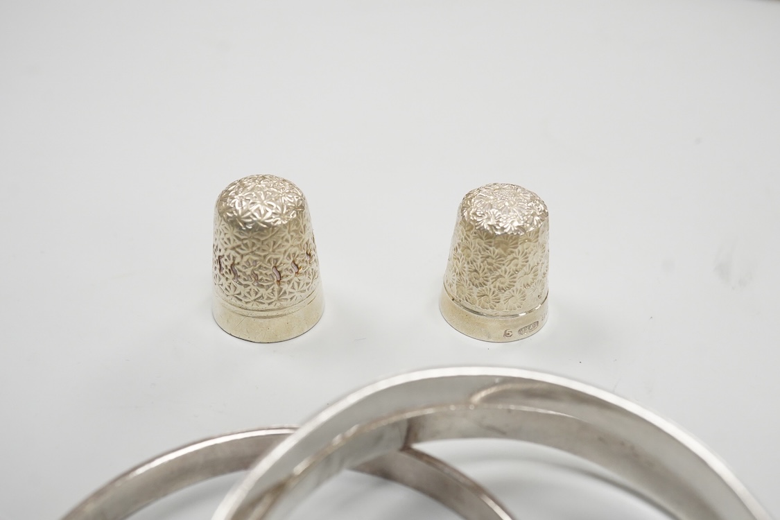 A collection of small silver to include a cigarette case, two napkin rings, three pairs of sugar tongs, a thimble, a lady's wrist watch and a mounted glass toilet jar. together with a 925 fob watch, a 935 mounted lighter